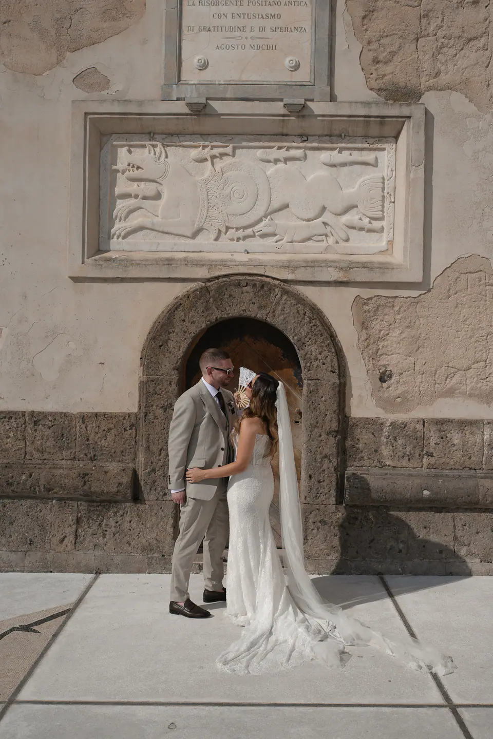 Couple in the doorway of an old stone building in Positano.