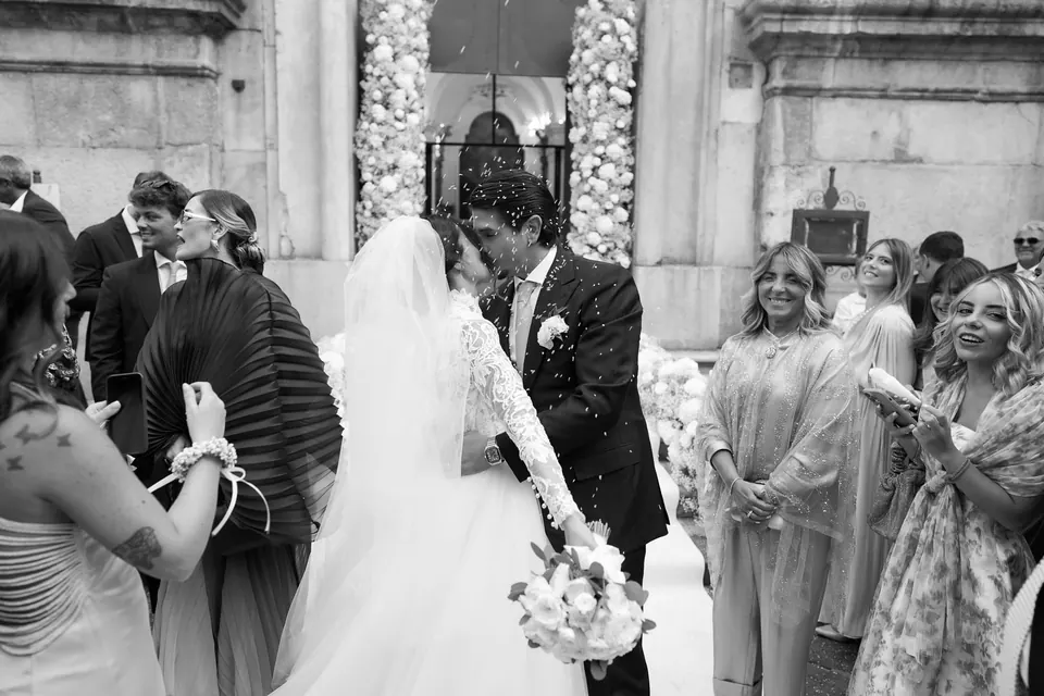 Bride and groom leaving the church under a shower of petals.