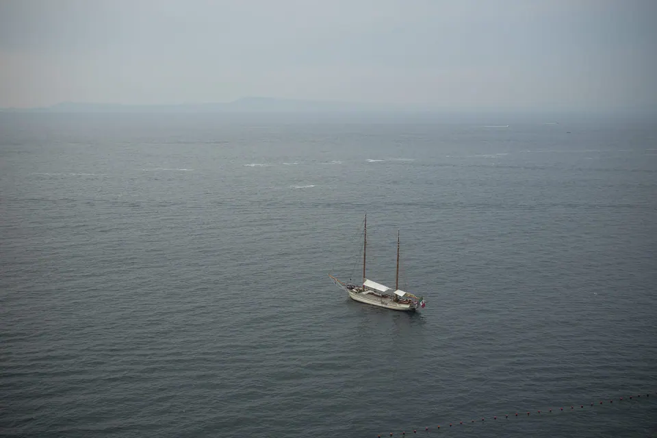 Sailboat floating on the calm Sorrento sea, peaceful Mediterranean scene before the wedding.