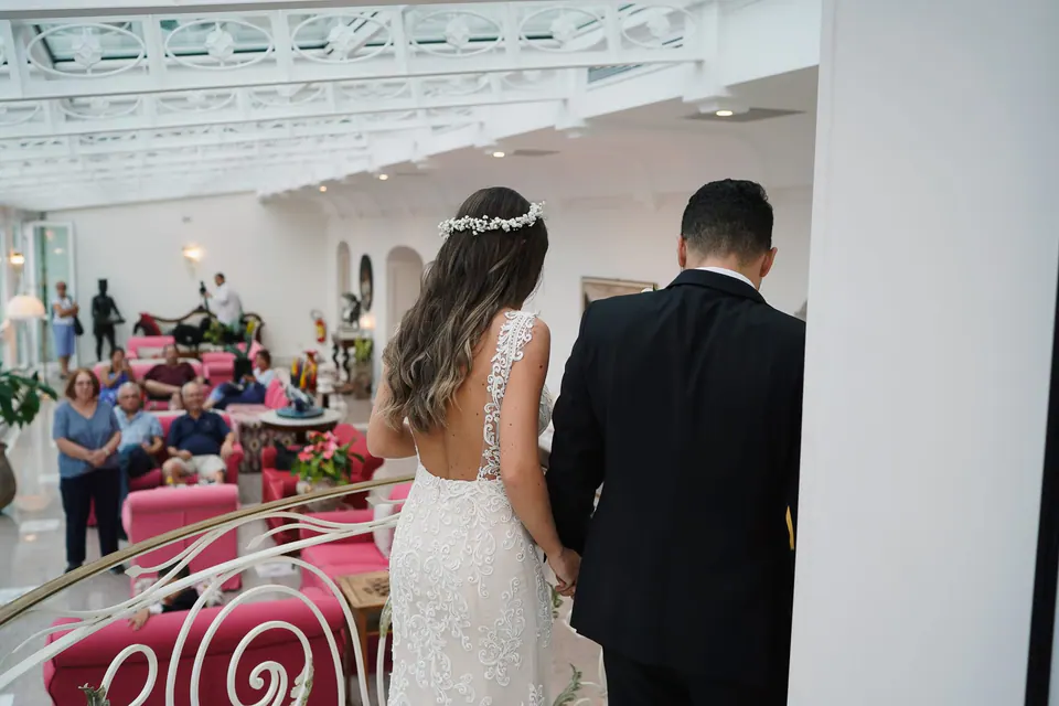 Bride walking down the aisle, the groom waiting ahead.