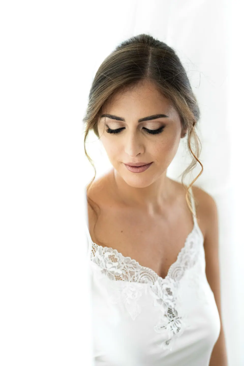 La sposa nel suo abito bianco si prepara per la cerimonia, un momento calmo e pieno di grazia.