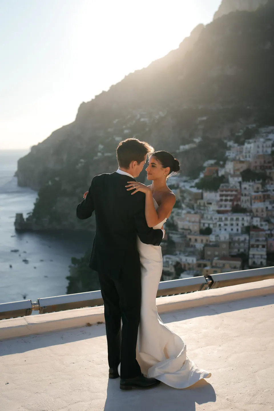 Bride and groom dancing on the terrace in the golden light.