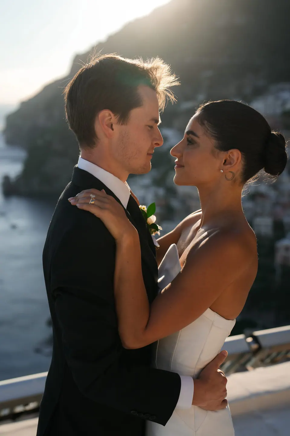 Bride and groom looking at each other at the railing.