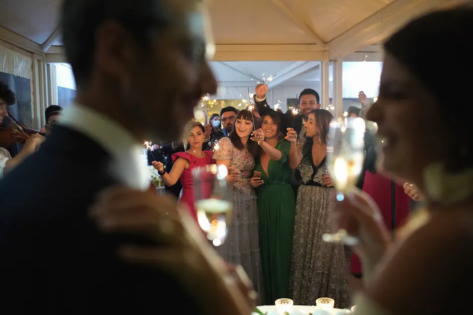 Bride and groom raising a toast with their guests at the reception.