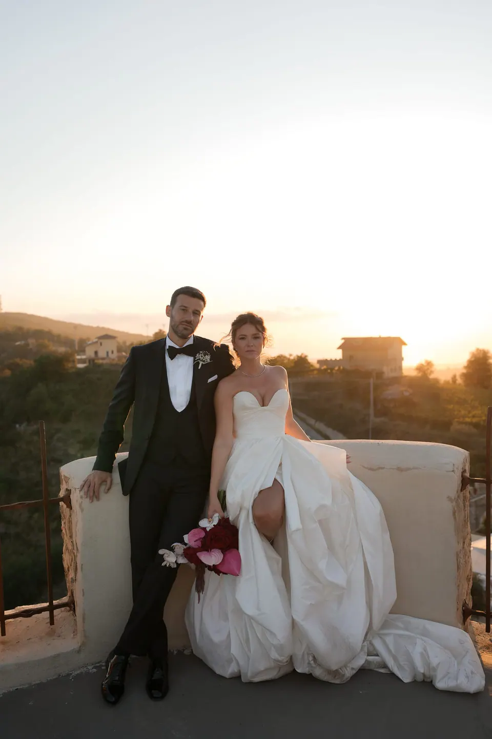 Bride and groom on the castle terrace at sunset at Castello di Rocca Cilento.