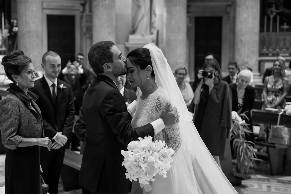 The couple greeted by guests outside the church in Naples.