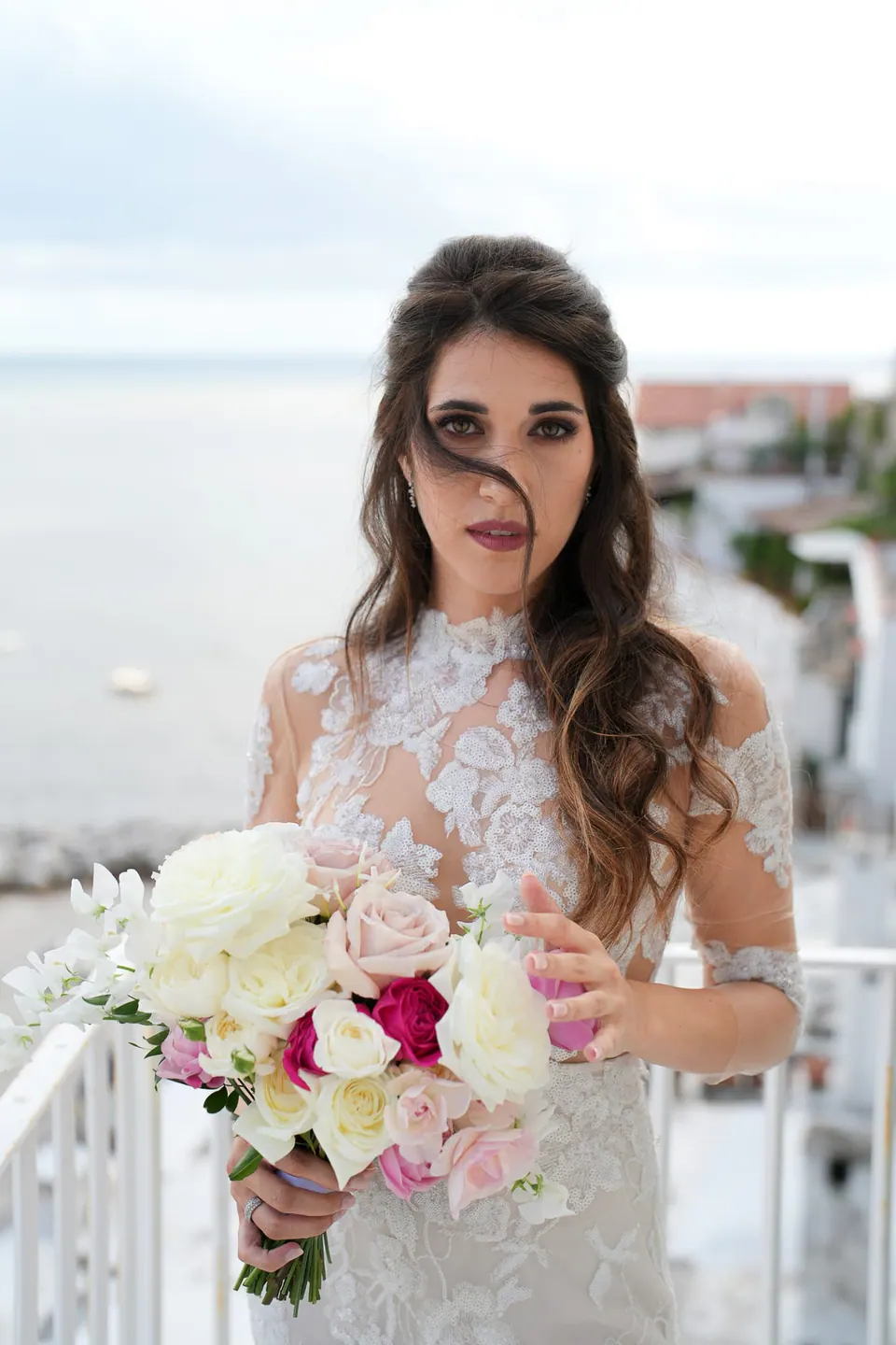Bride holding her bouquet of white and blush flowers, radiant and poised before the ceremony in Ravello.