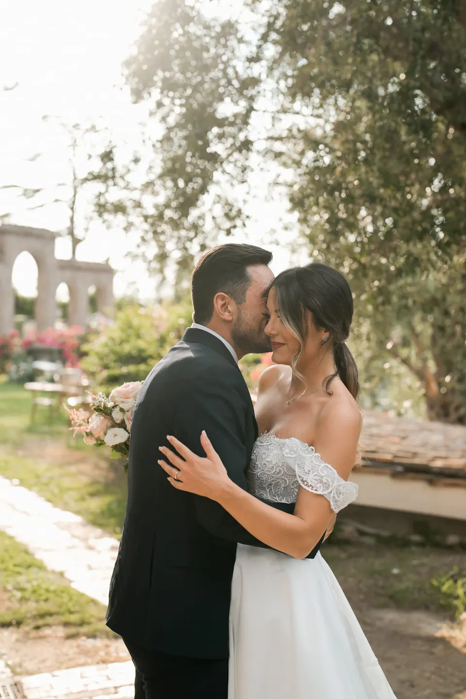 Bride and groom embracing in the garden