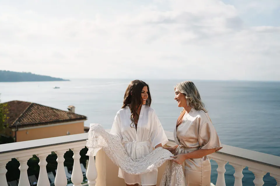 Bride and bridesmaid looking at the sea from the terrace of Hotel Corallo, Sorrento.