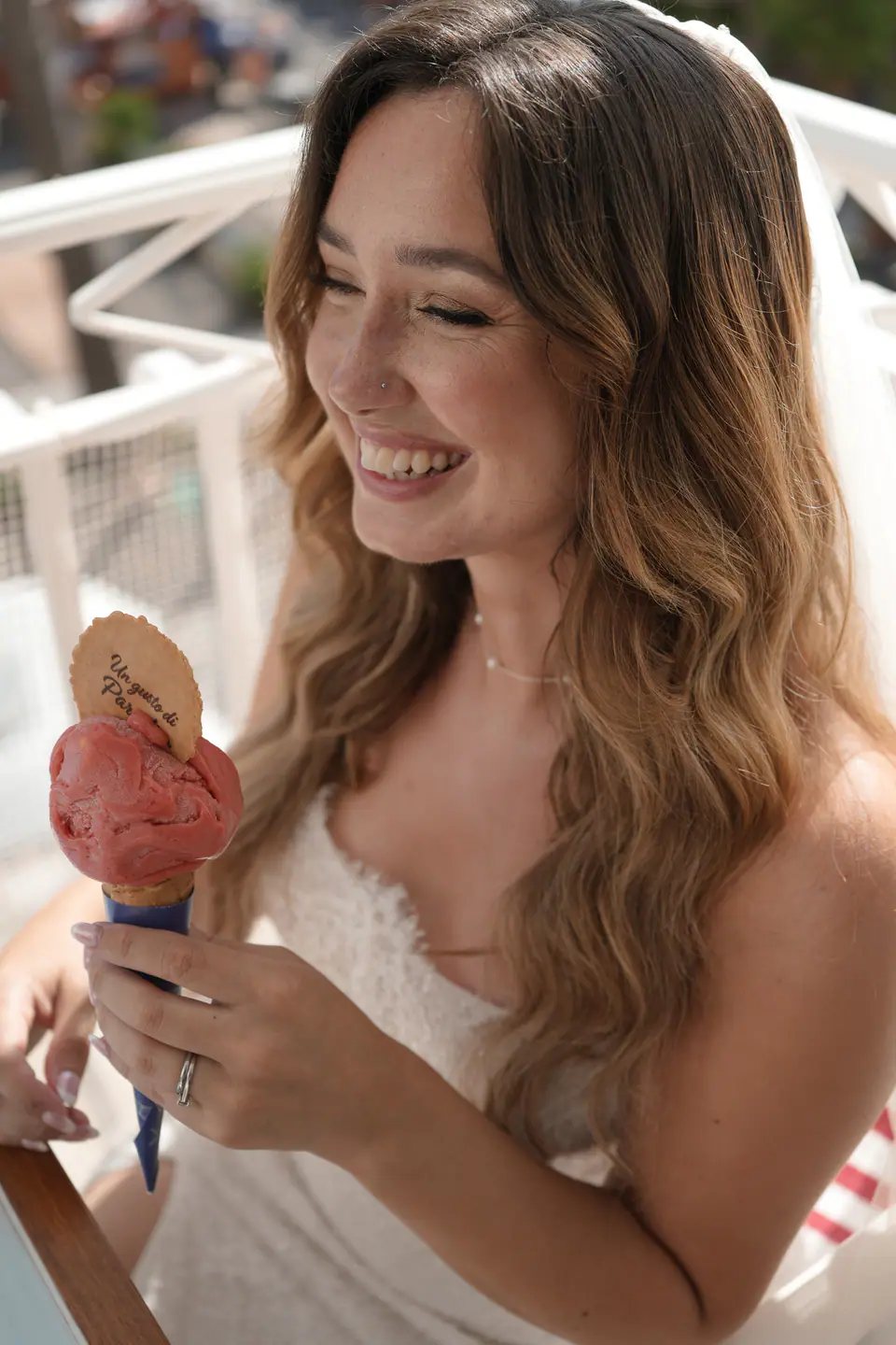 Bride laughing with a gelato in her hand.