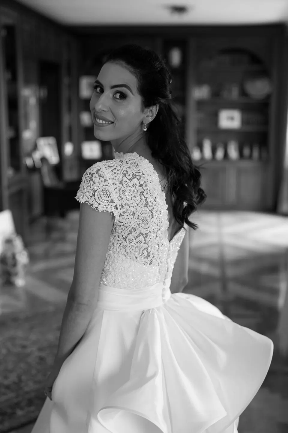 Black and white photo of the bride looking back over her shoulder
