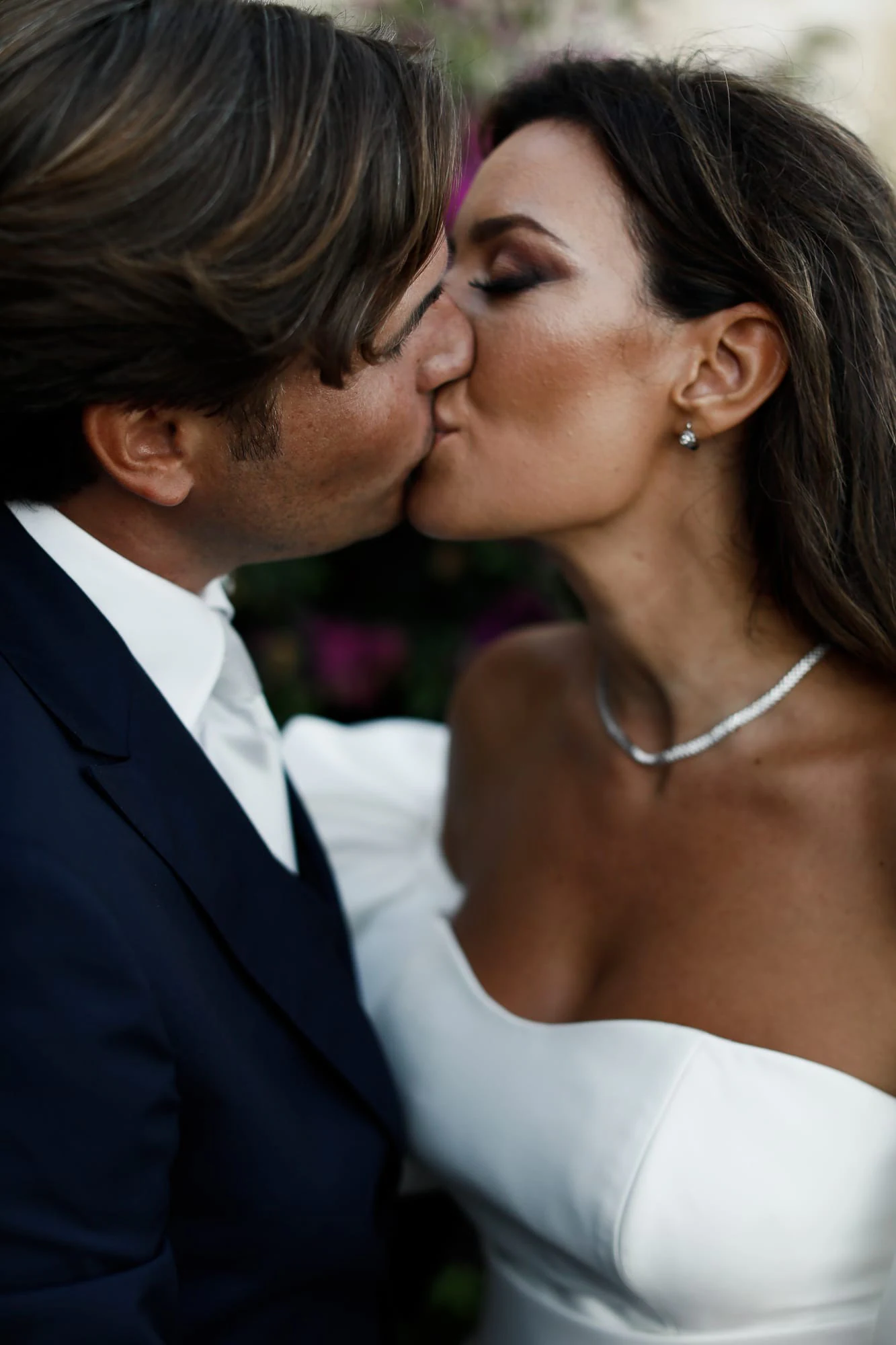 Close-up of the bride and groom kissing at La Conca sul Mare.