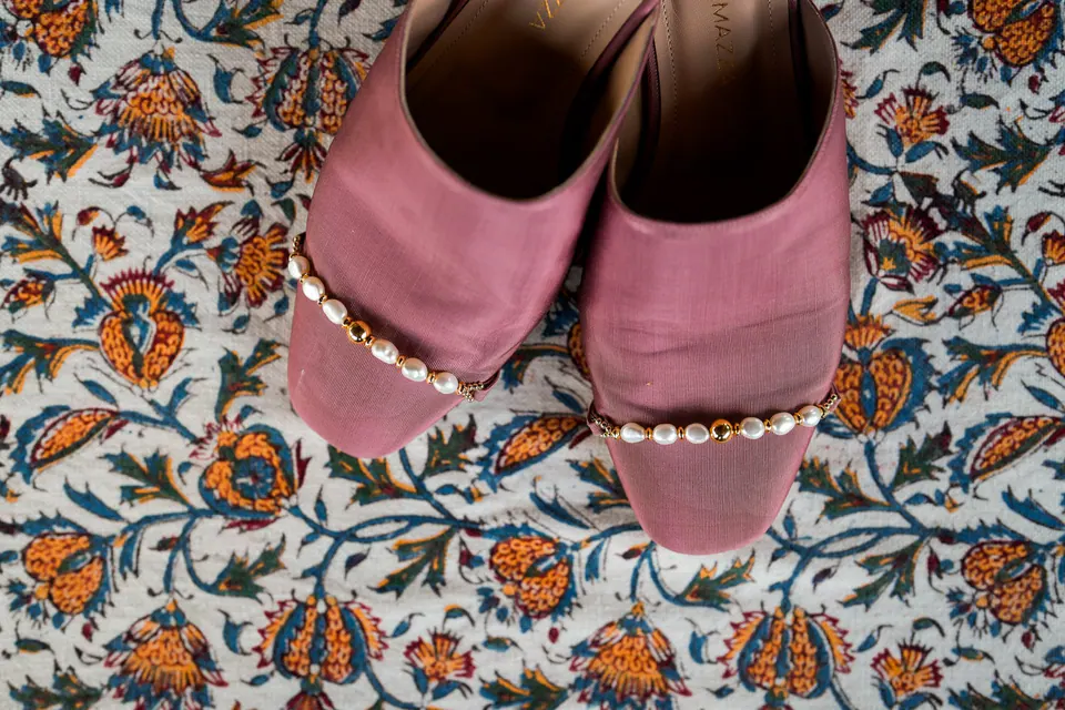 Pink bridal shoes on patterned tiles.