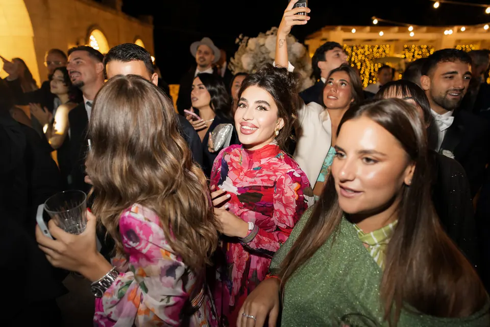 Guests laughing and dancing at the party