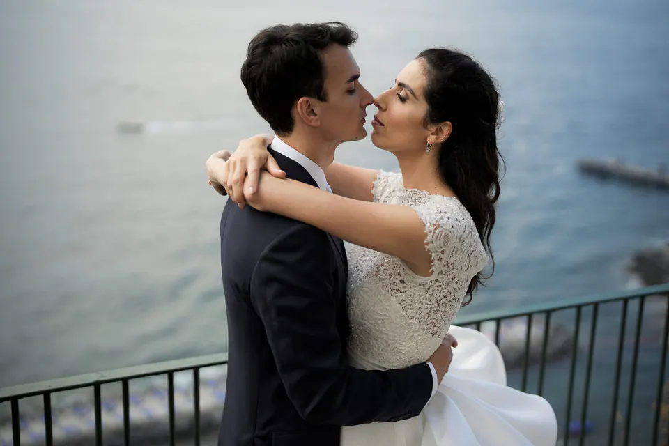 Couple kissing on the terrace overlooking the Gulf of Naples, pure Italian romance.