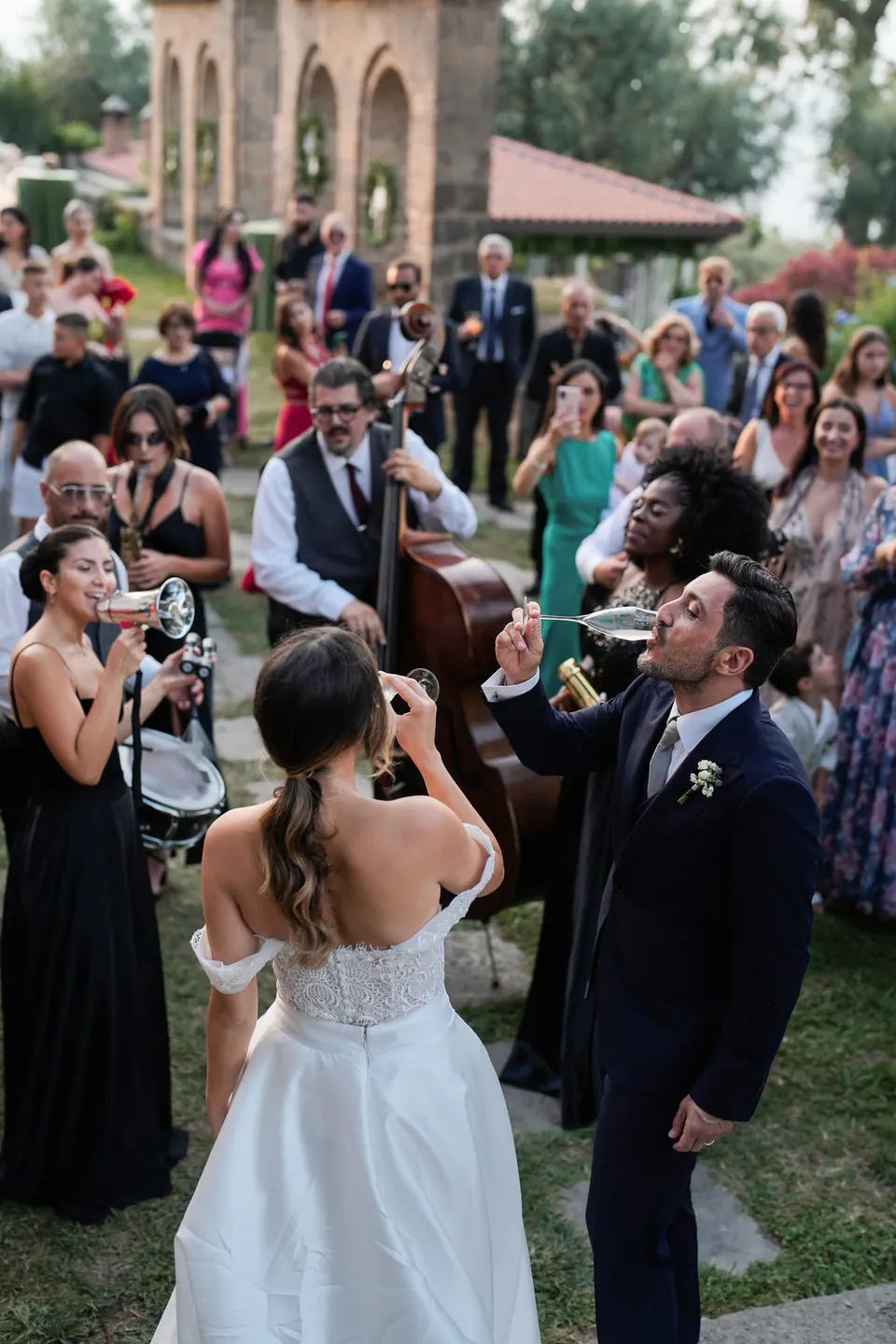 Bride and groom arriving among the guests in the garden