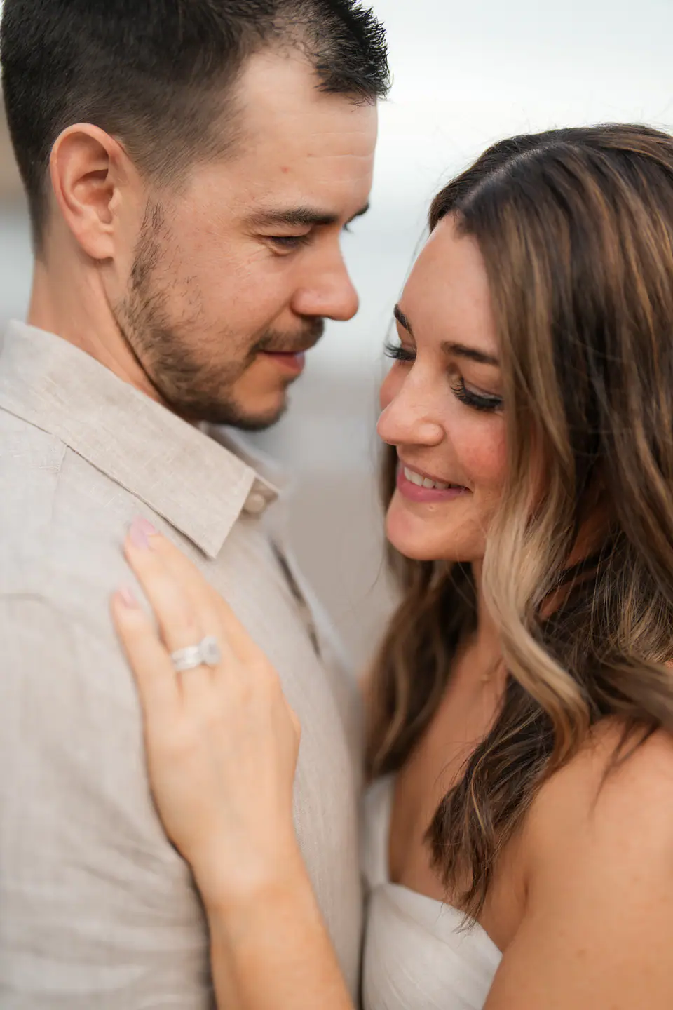 Bride resting her hand with her ring on the groom's chest.