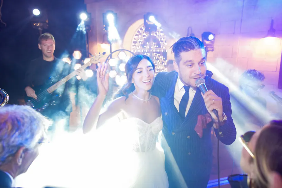 The couple dancing close under string lights at Tenuta San Domenico, Caserta.
