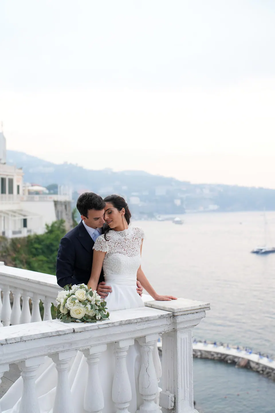Bride and groom at the balustrade of La Cocumella above the Sorrento coast