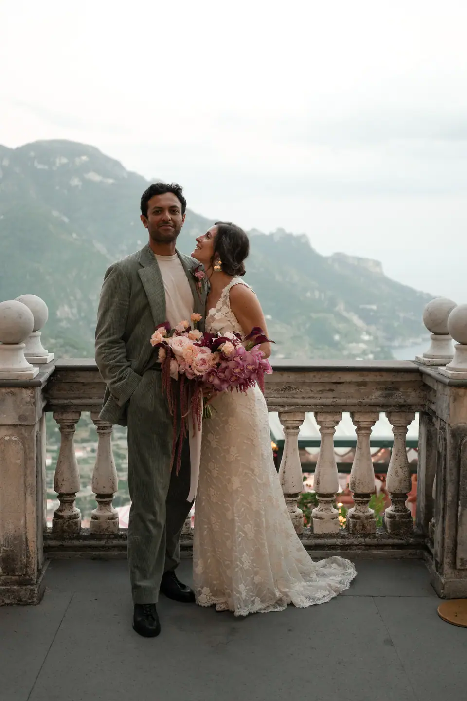 Couple at the stone balustrade of the terrace of Palazzo Avino, the coast behind.