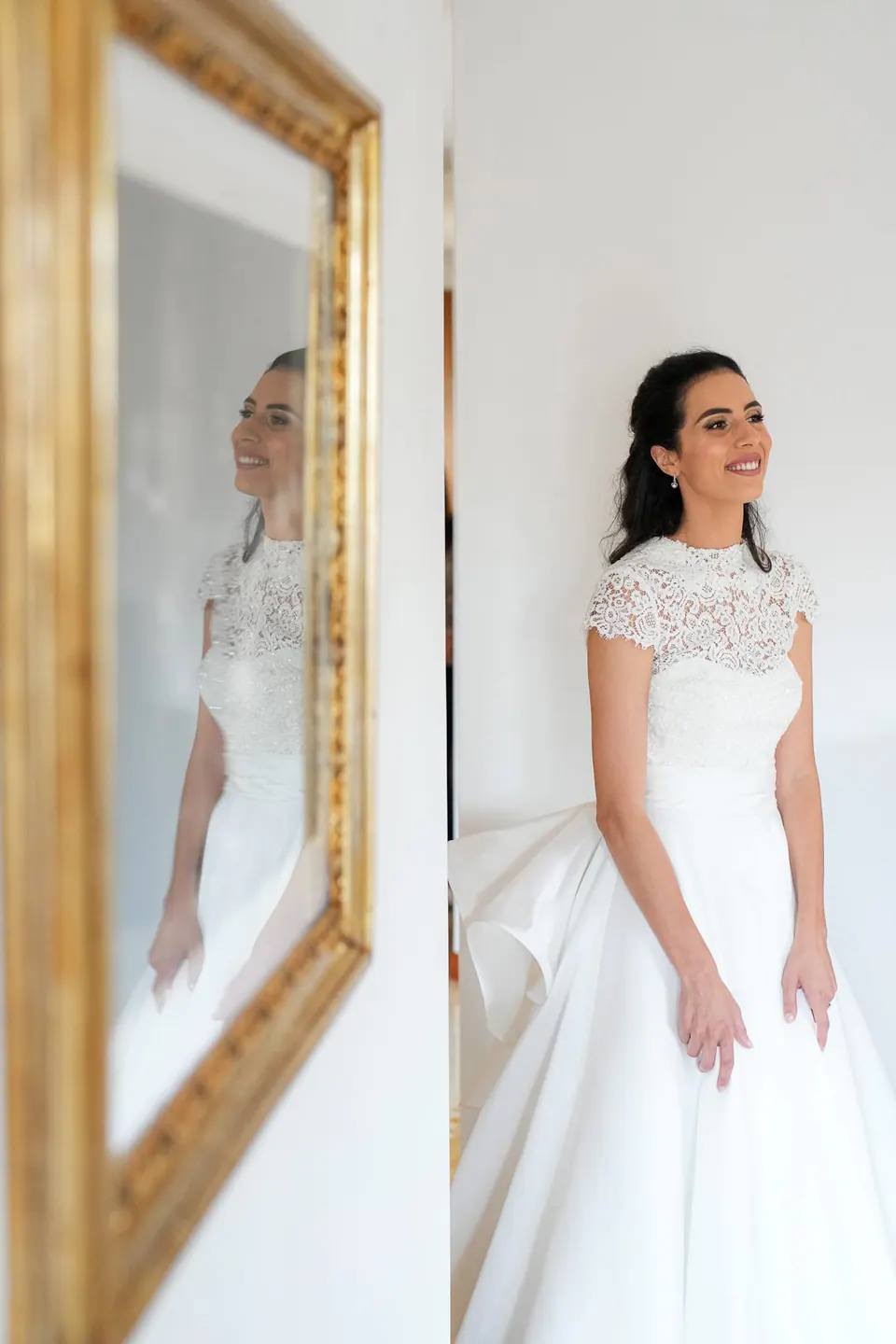 Bride standing beside a gilded mirror