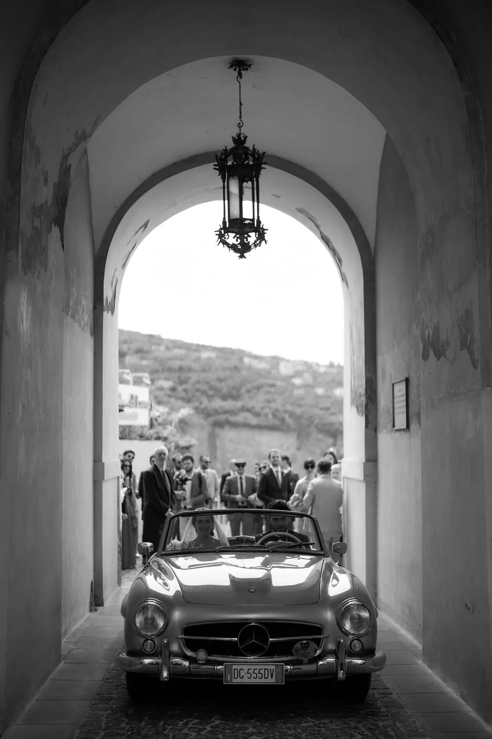 Schwarzweißfoto des Mercedes-Oldtimers, gerahmt von einem Bogengang.