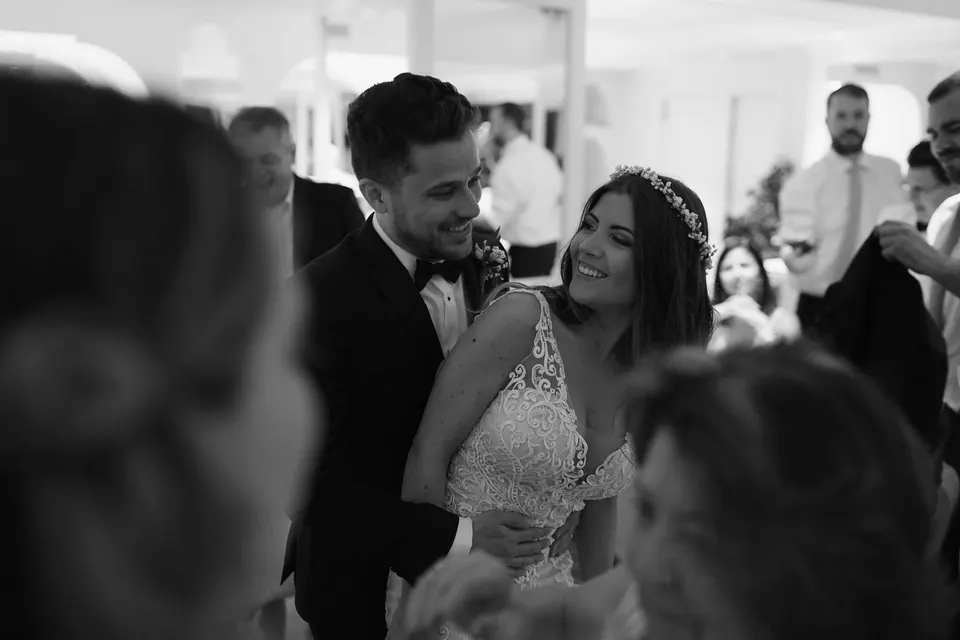 Black and white photo of the bride and groom among guests at Hotel Corallo in Sorrento.
