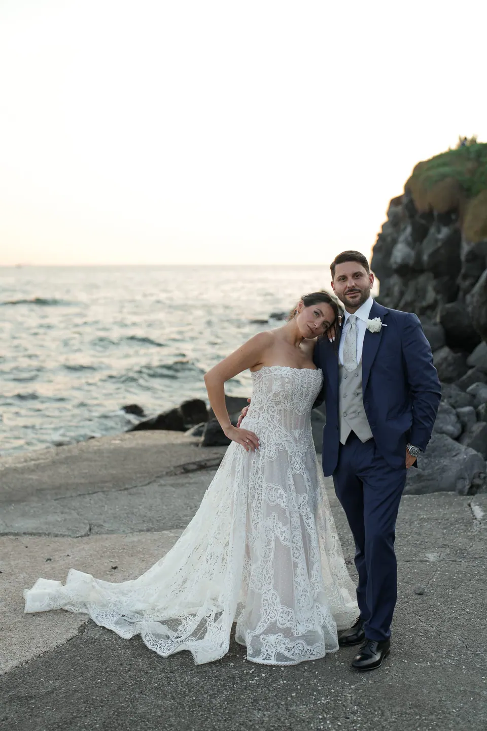 Bride and groom on the rocks by the sea at Villa Balke in Naples.