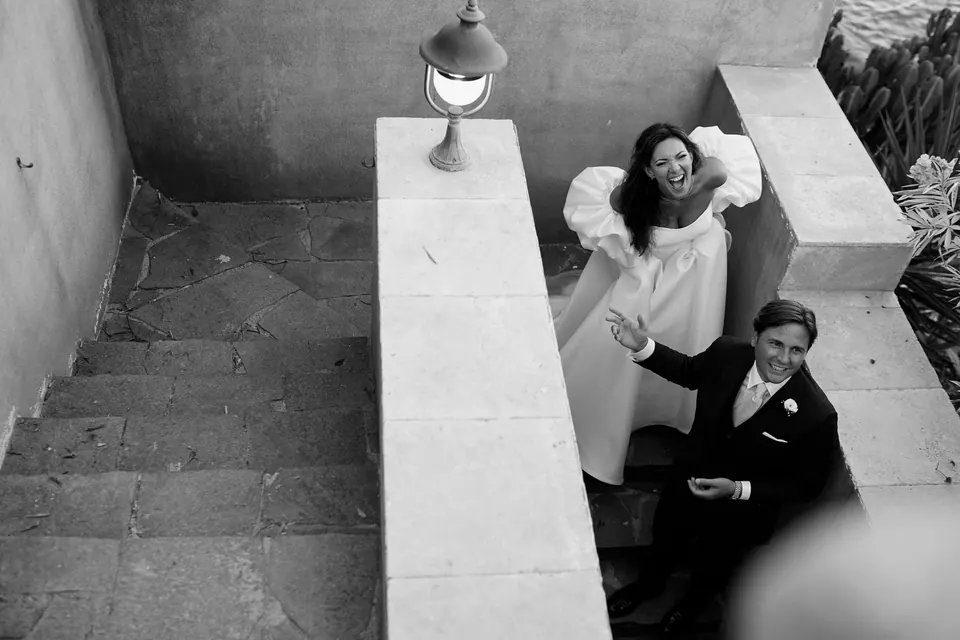 Black and white photo from above of the bride and groom on the stone steps of La Conca sul Mare.
