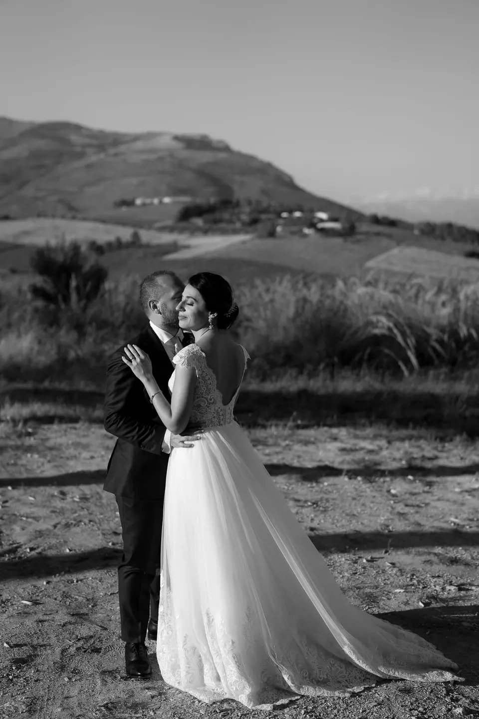 Bride standing in open countryside, cinematic destination wedding portrait Sicily.