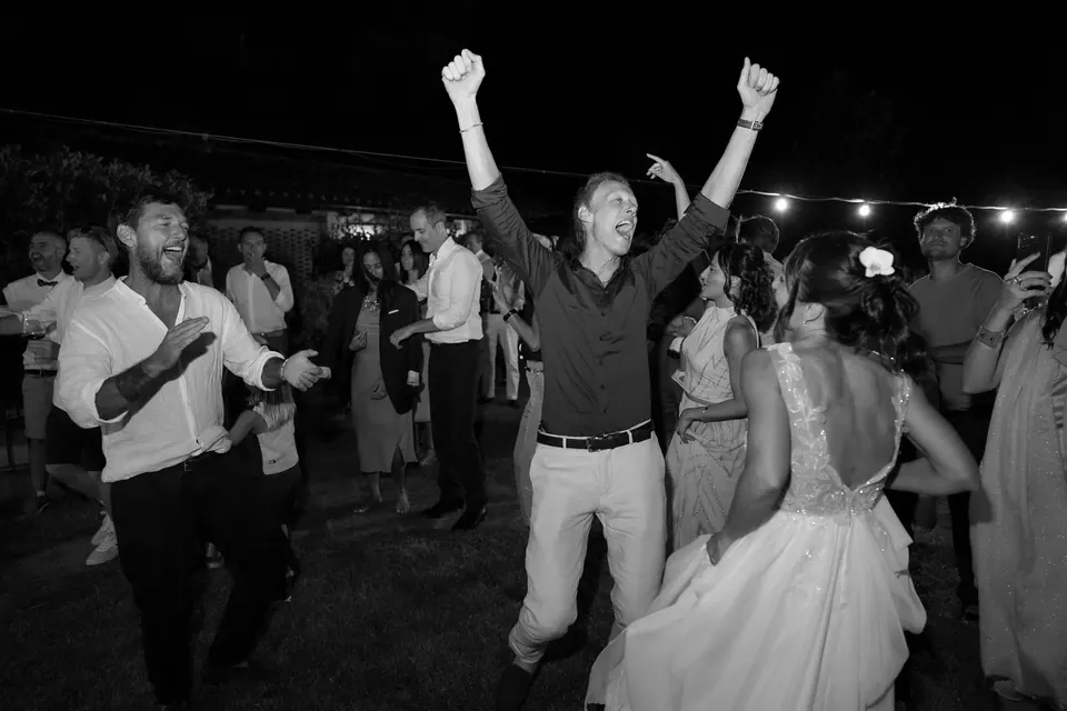 Guests dancing under the stars, energetic countryside wedding party in Assisi.