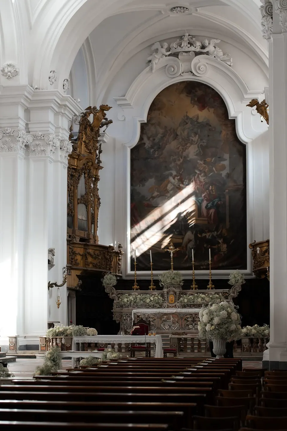 The interior of a white baroque church before the ceremony