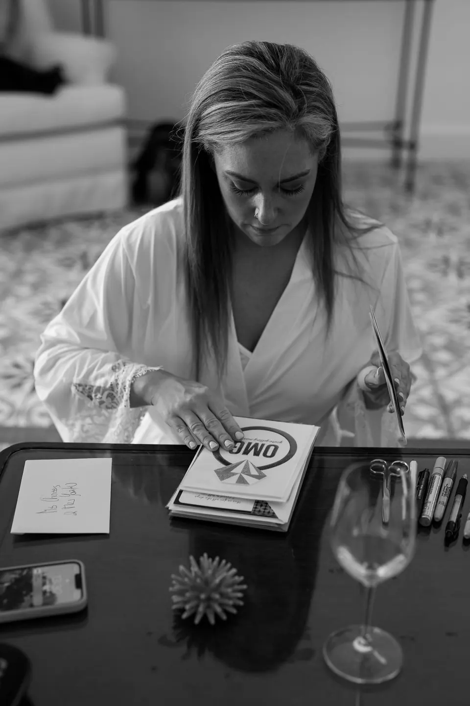 Bride writing a note before the ceremony, peaceful and introspective moment.