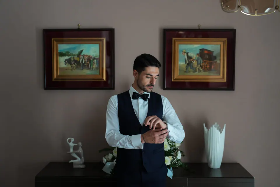 Groom adjusting his cufflinks before the ceremony.