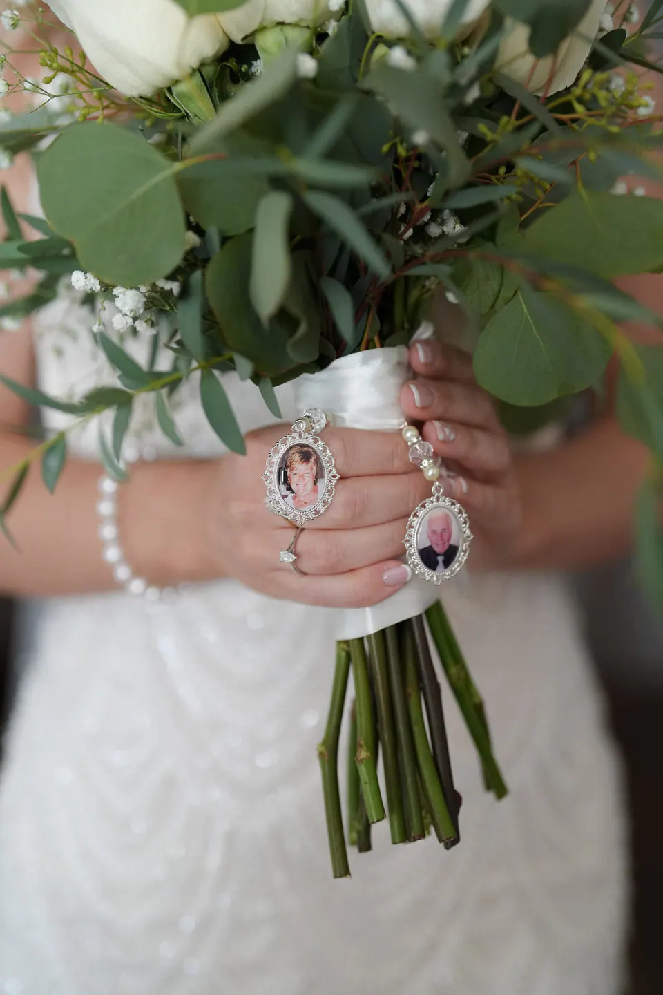 The bride's bouquet with a small photo charm on the stems