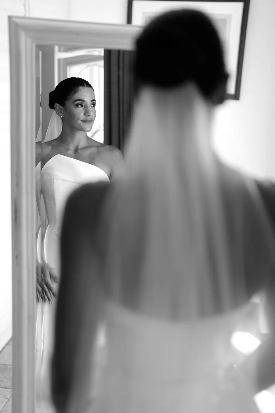 Black and white photo of the bride's veil and reflection in a mirror.