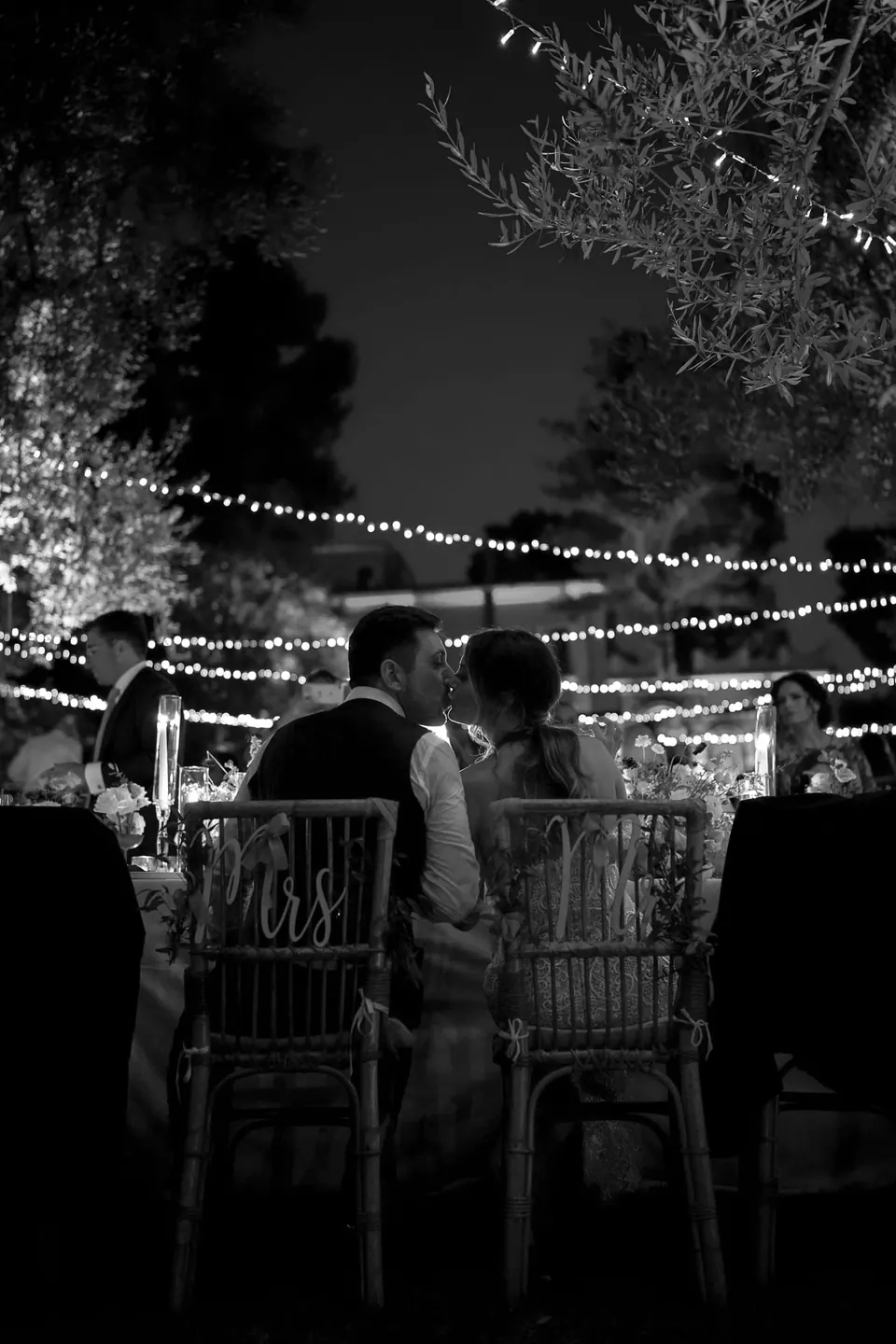Reception tables lit by candlelight, creating a romantic evening atmosphere.