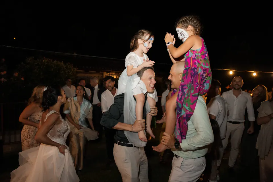 Guests dancing to live music, festive evening celebration in the garden.