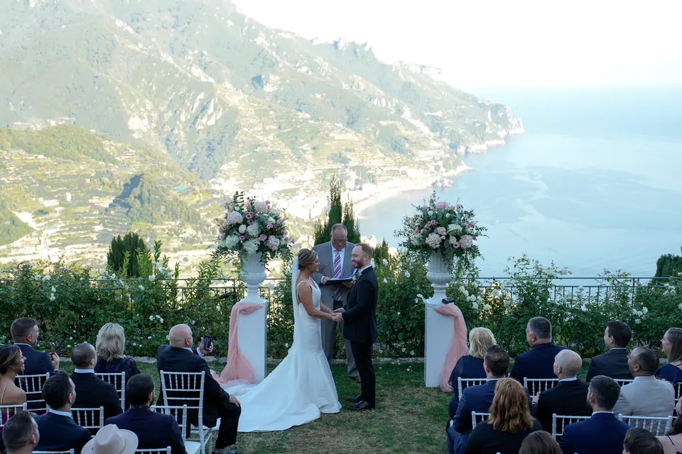 Couple exchanging vows with the Amalfi cliffs and sea as their backdrop.