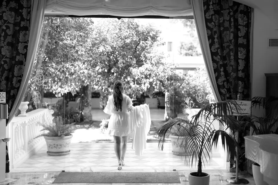 Bride walking down a bright hallway at Relais Blu.