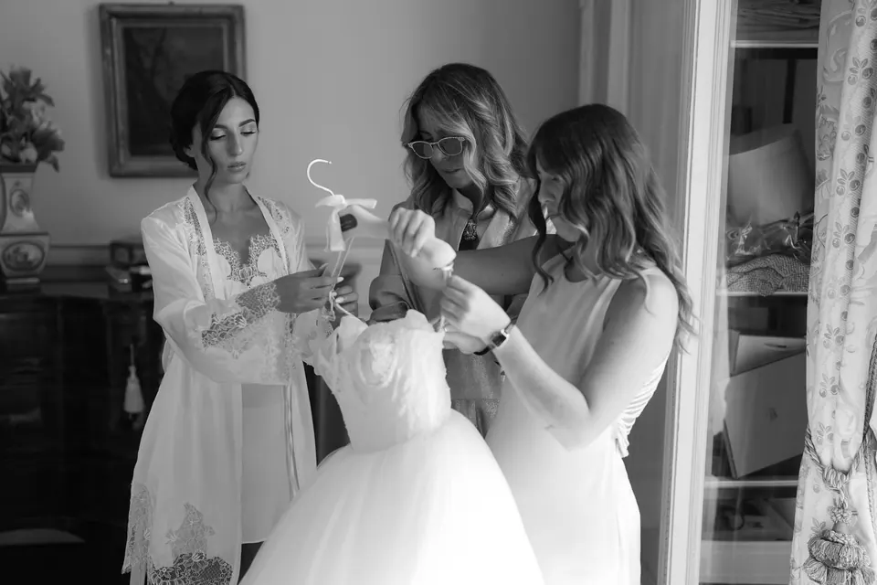 Black and white photo of the bride laughing with a bridesmaid.