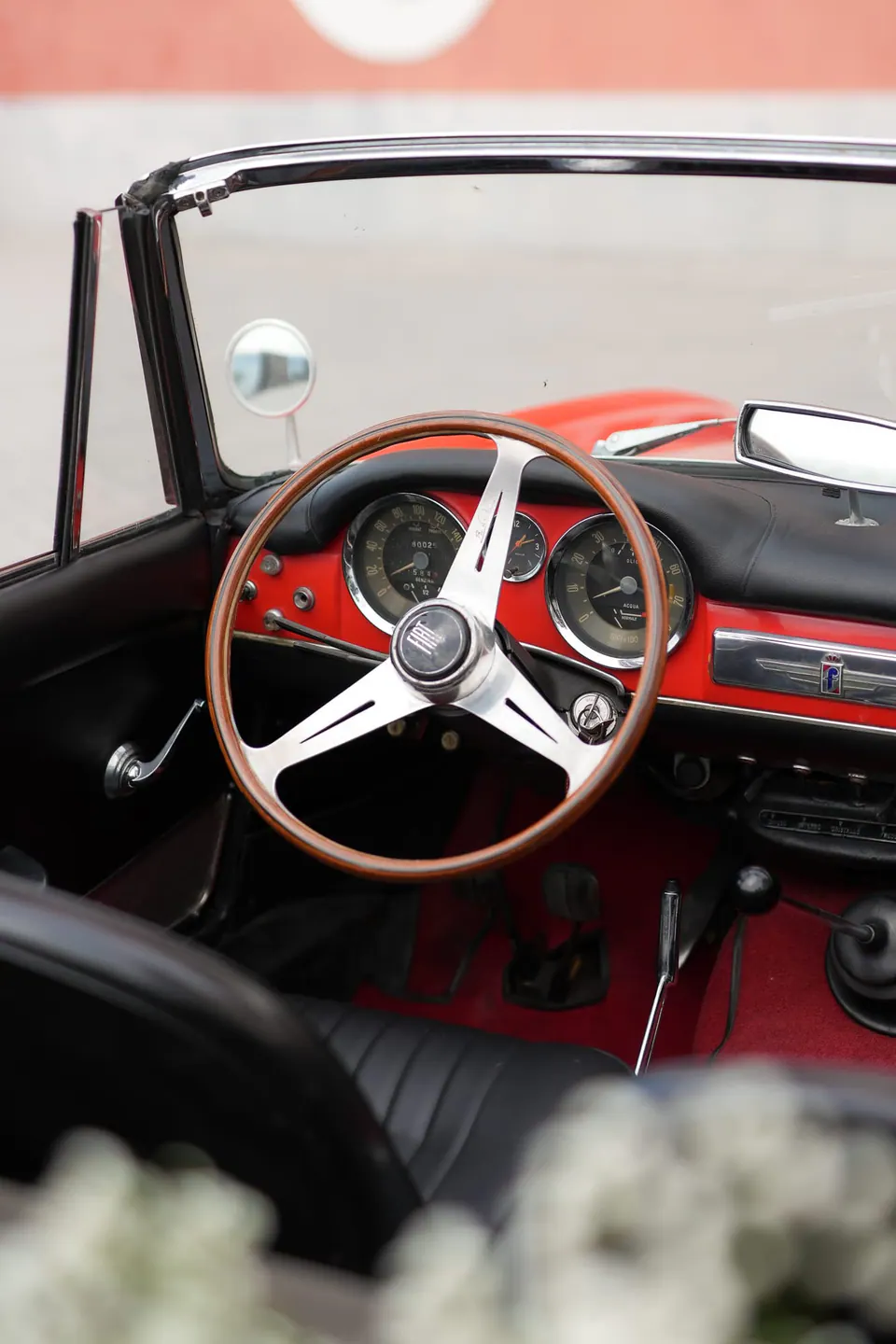 Steering wheel of the red vintage car.