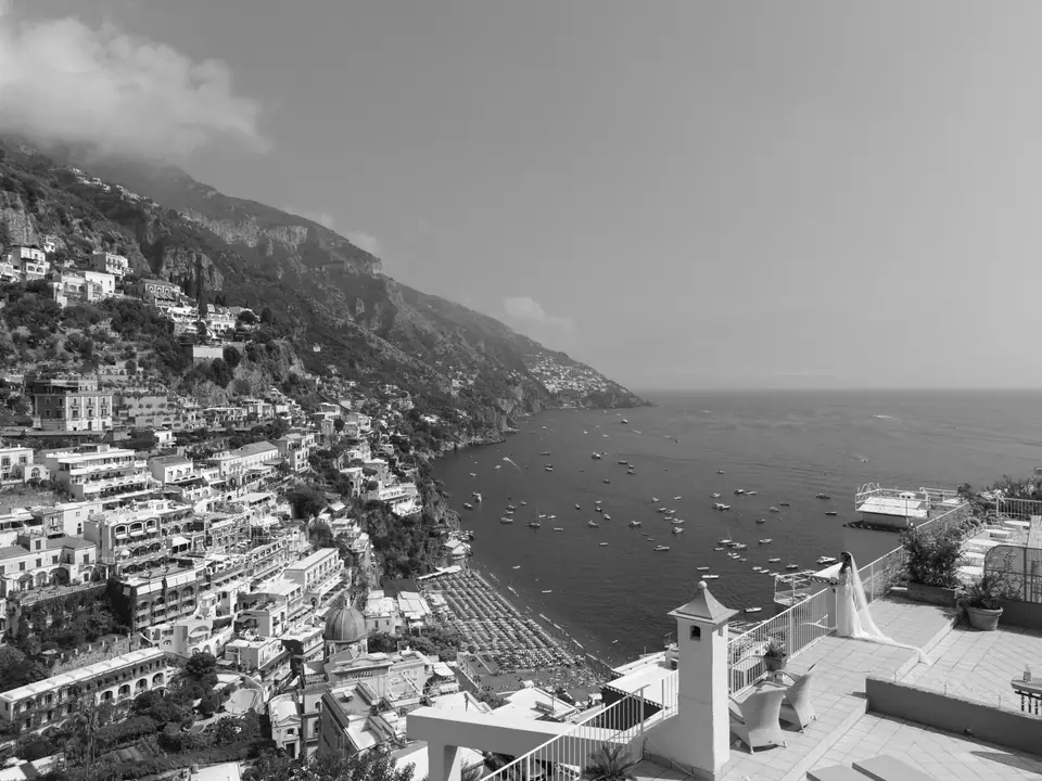 Black and white view of Positano and its bay from a terrace above the town.