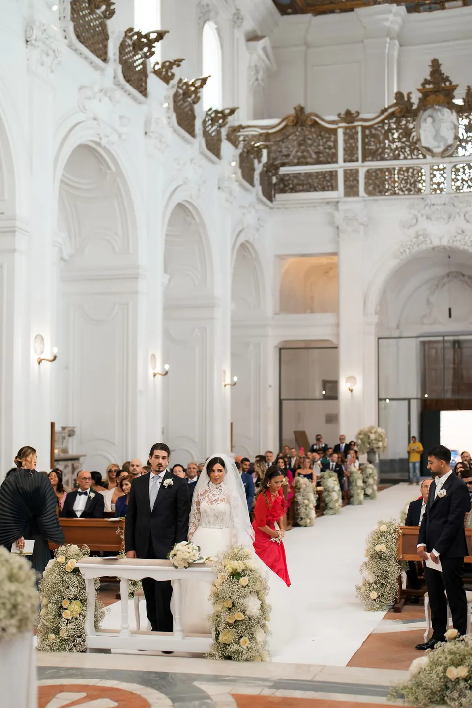 Guests walking down the flower-lined aisle at Tenuta San Domenico.