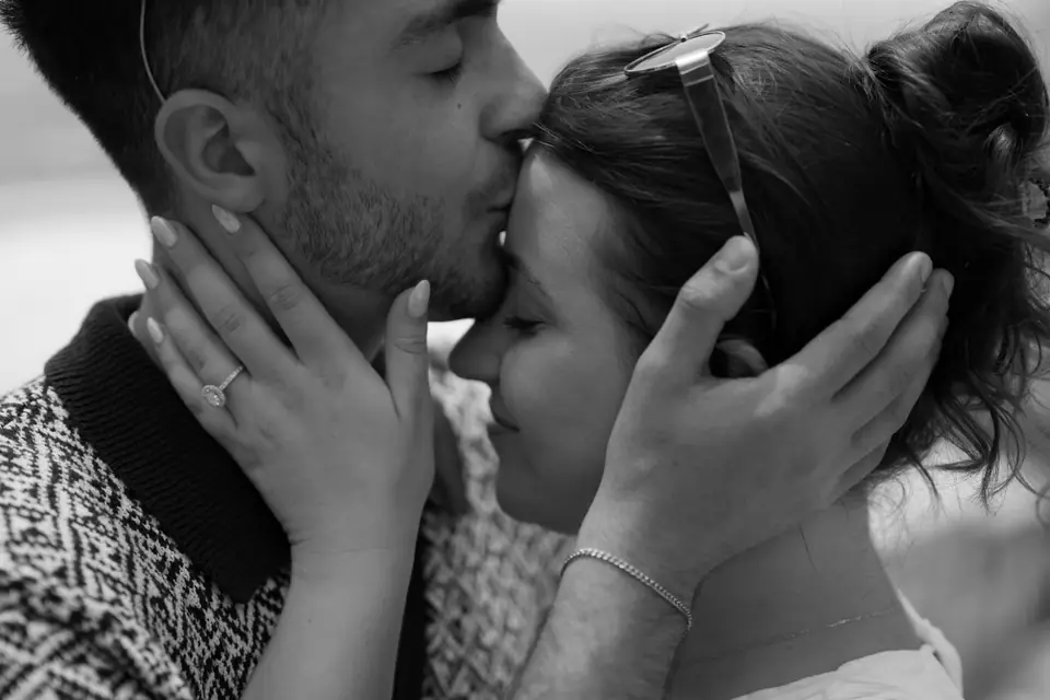 Black and white close-up of the couple, his forehead against hers.