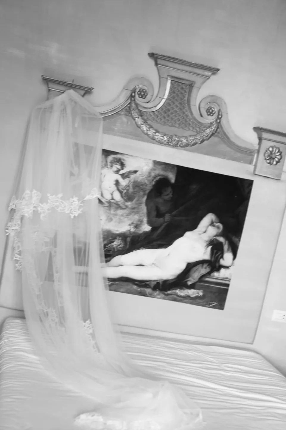 Black and white photo of the veil hanging beside a painting
