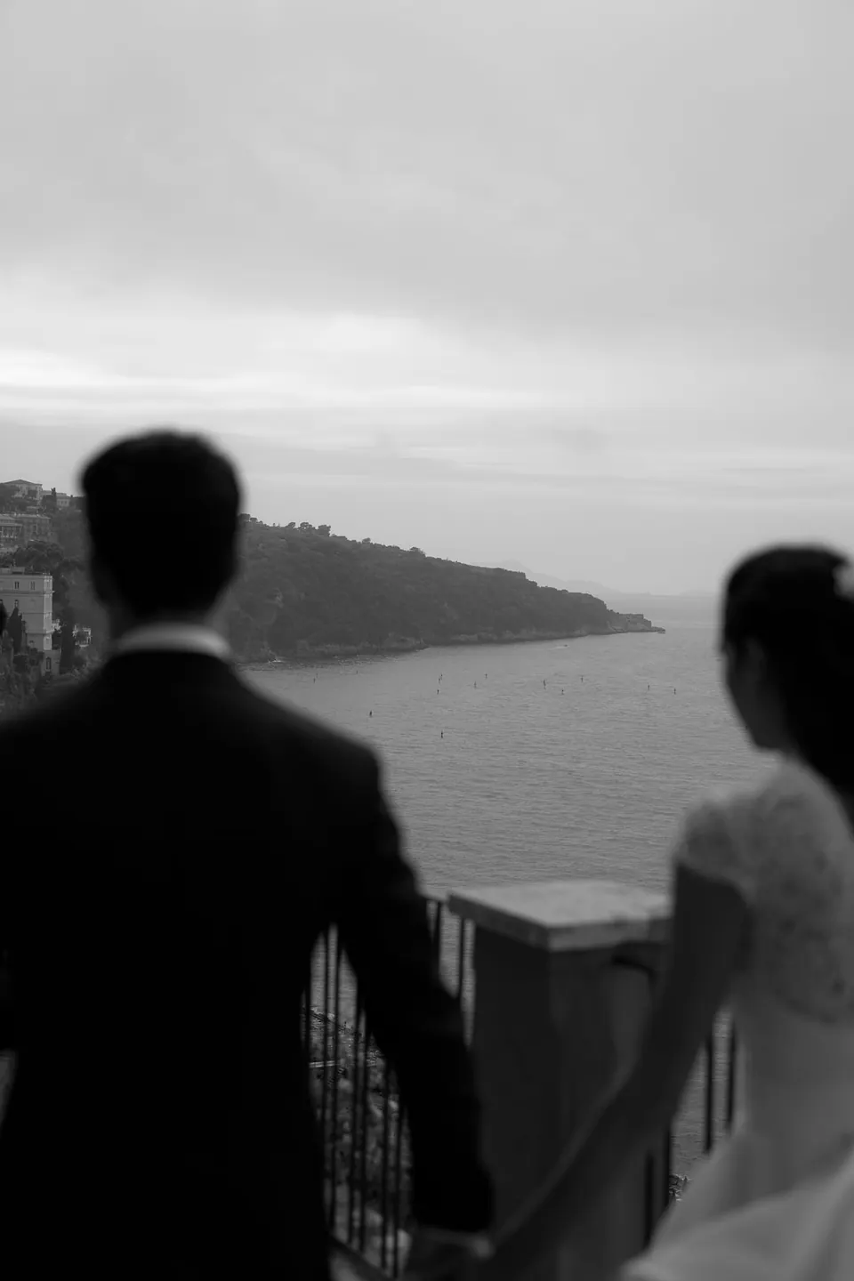 Black and white photo of bride and groom looking out at the Sorrento coast