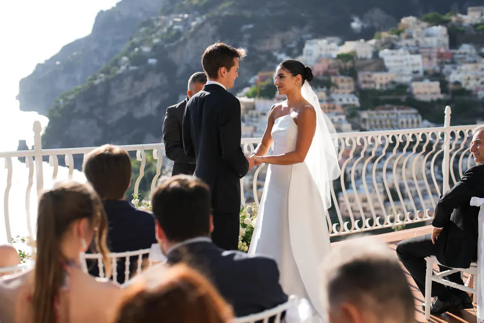 Ceremony on the terrace of Villa Oliviero, guests seated before Positano.