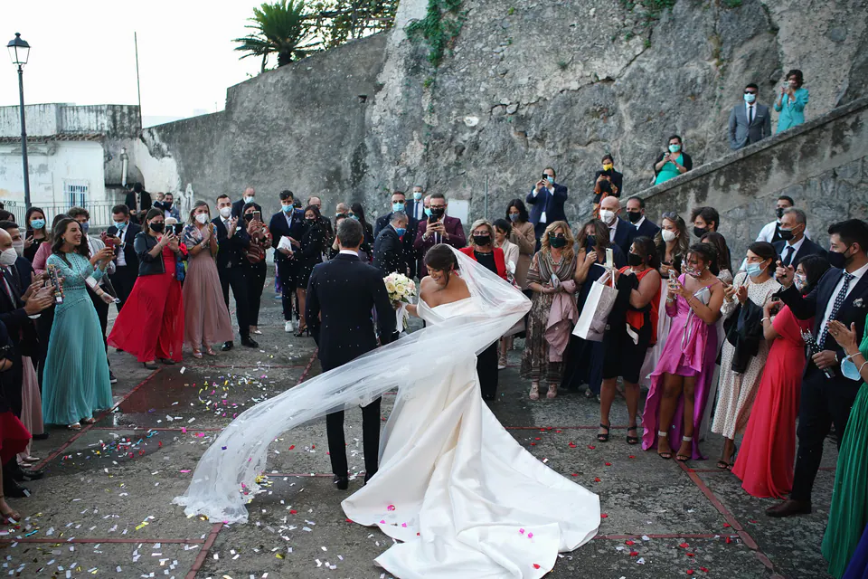 Bride spinning as guests cheer outside the church in Amalfi.