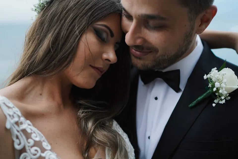 Close-up portrait of the bride and groom embracing, romantic editorial wedding photography Italy.